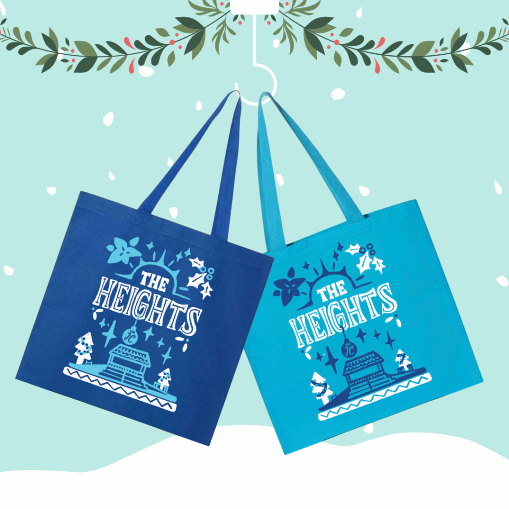 Two versions of the exclusive The Heights tote bags for sale at the Heights Holiday Market. One in dark blue and one in aqua blue.