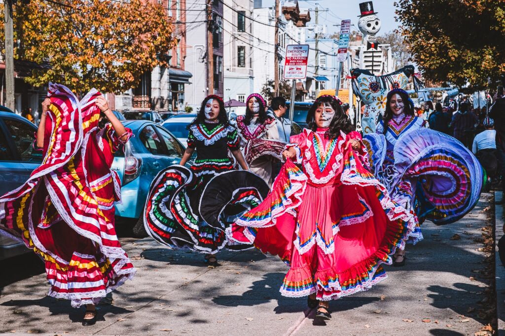 Day of the Dead Parade at Riverview Farmers Market - Mexican Folkloric Dancers at the front of a giant Puppet Parade.